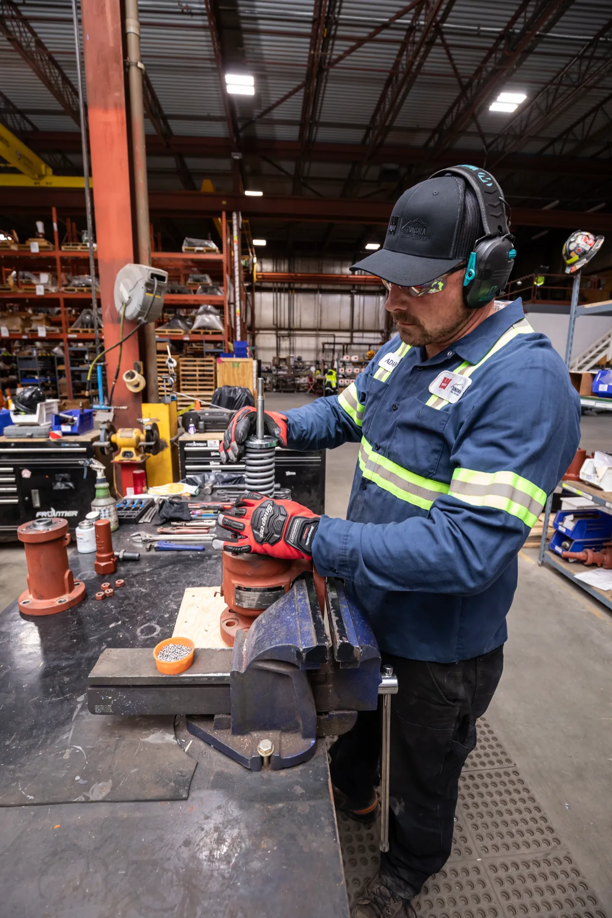 Tundra technician assembling a pressure relief valve in the valve shop