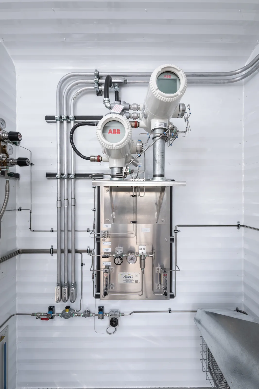 ABB analyzers above a stainless sample-conditioning panel built by Tundra